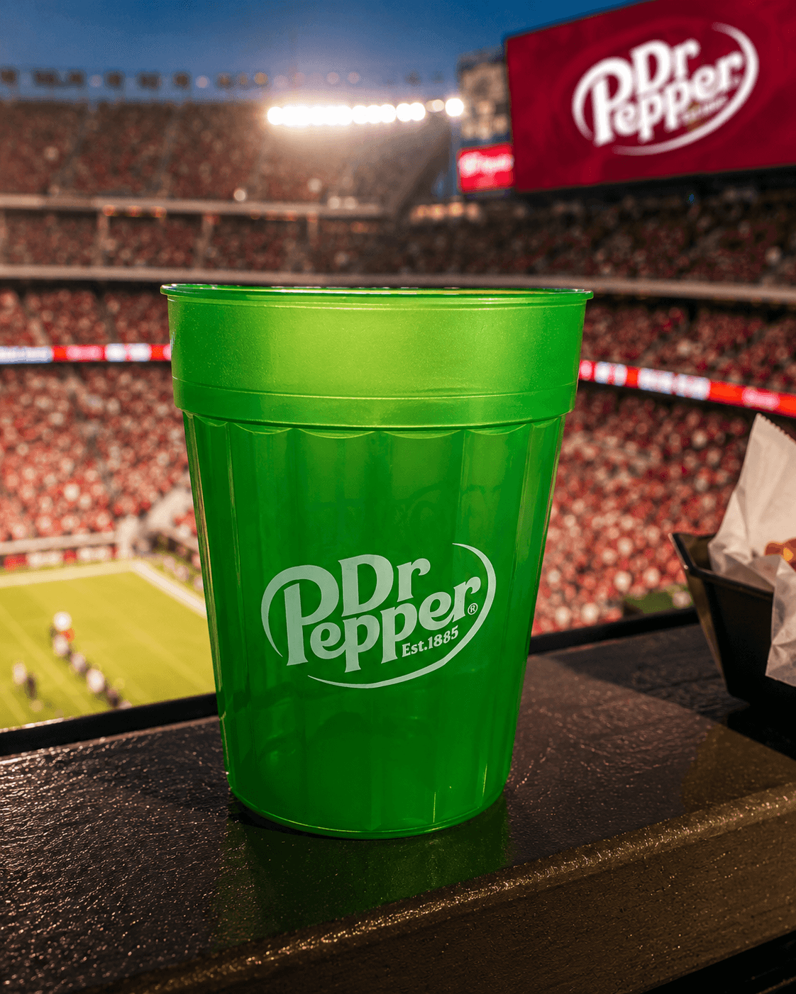 Custom Dr Pepper stadium cup in use at a football game